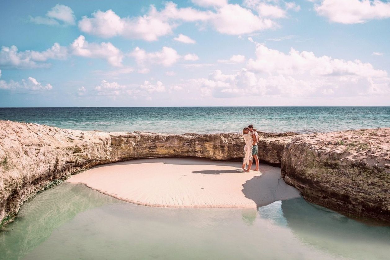 Honeymoon couple on a private beach picnic